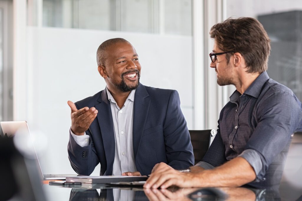 two men talking.