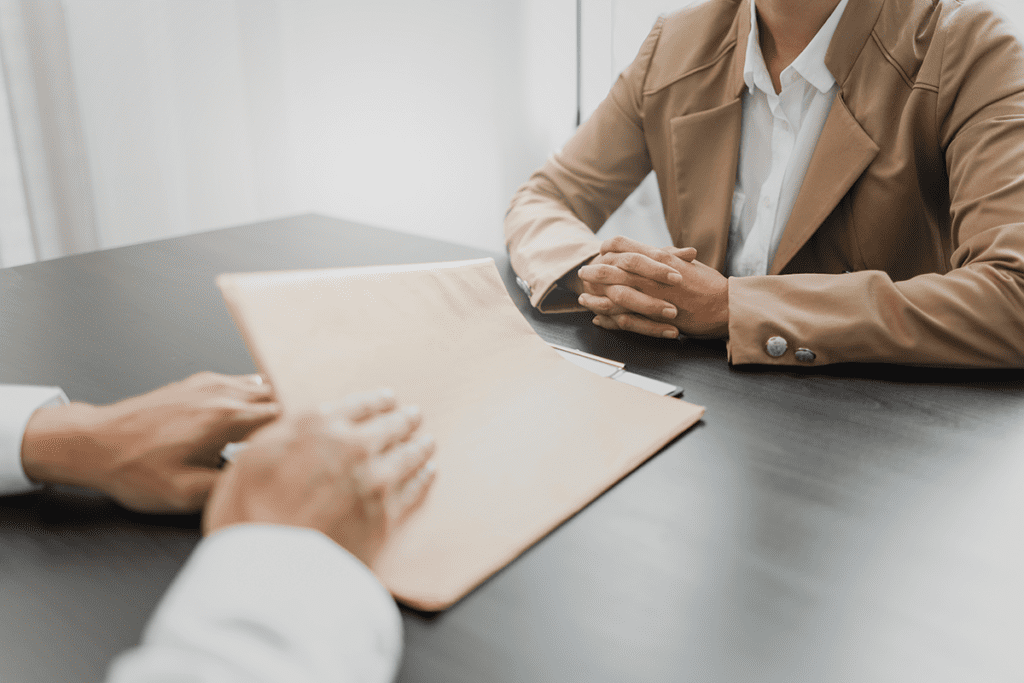 Attorney with legal documents discussing with client about legacy case.