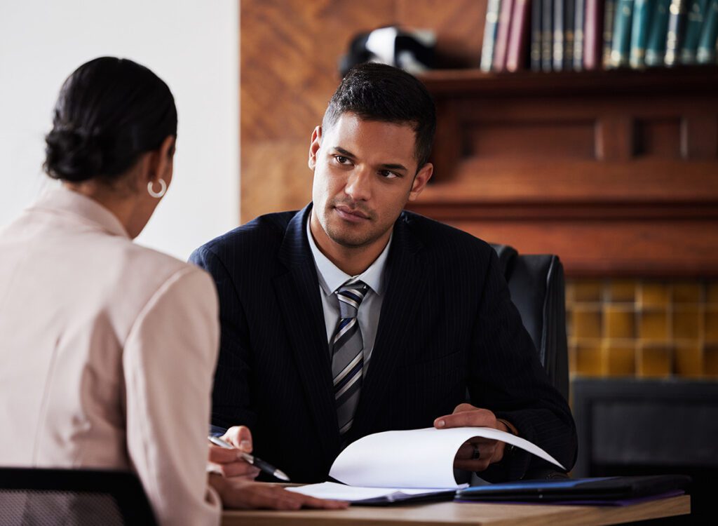 Attorney sitting down with client.